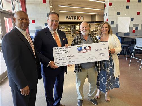 Steven Lanford with oversized check and prize patrol